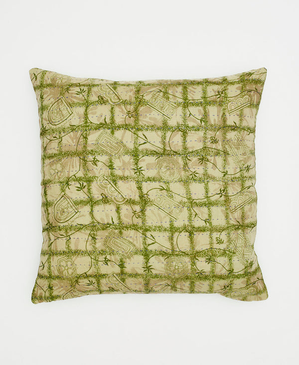 pale green cotton throw pillow with a darker green grid pattern and swirling vines