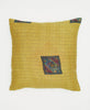 yellow throw pillow with small decorative squares with paisleys and stripes