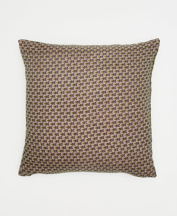 beige sustainable throw pillow with small green flowers