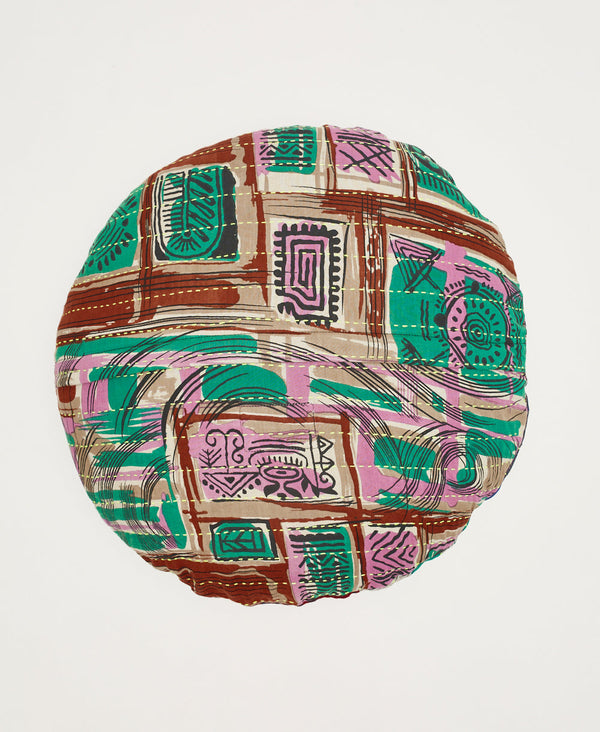 Abstract patterned round throw pillow featuring pink and teal designs and yellow traditional kantha hand stitching 