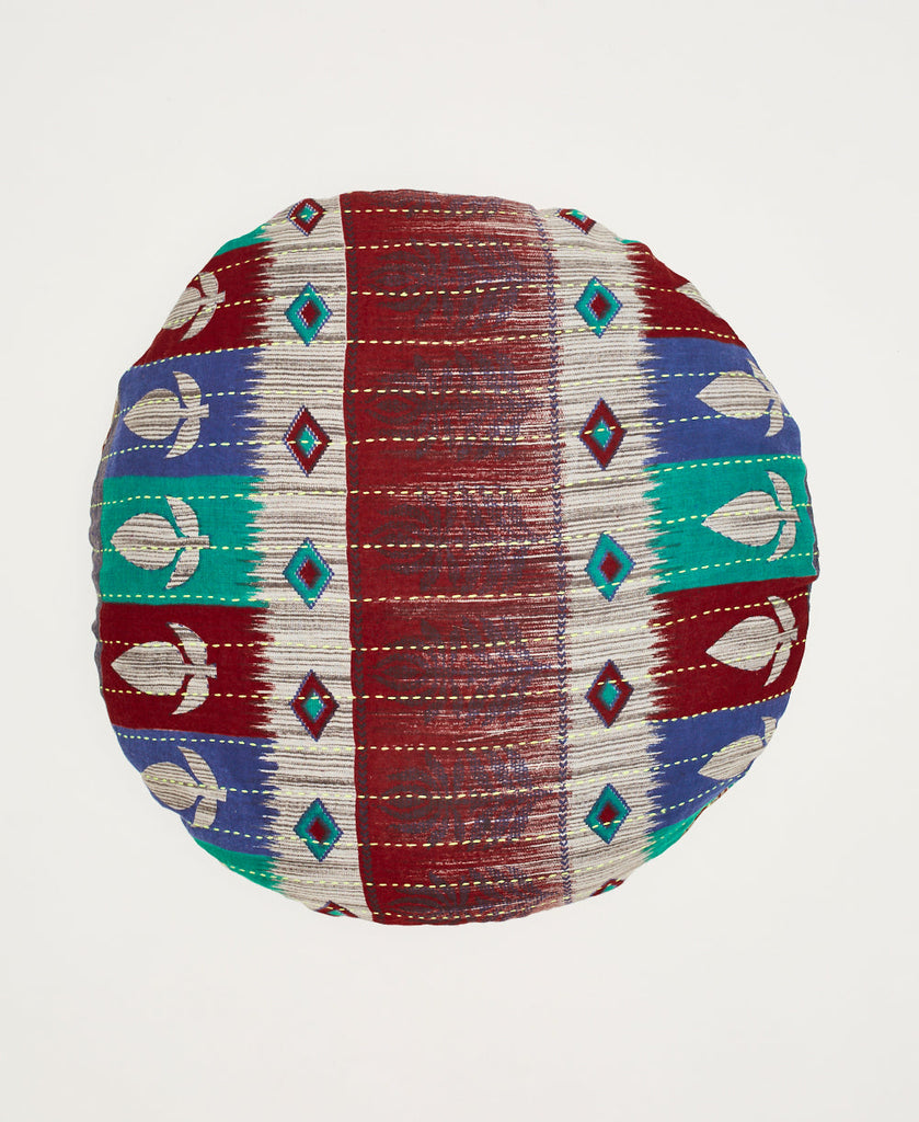 Round artisan made vintage cotton throw pillow featuring a red, blue, grey. and teal pattern 