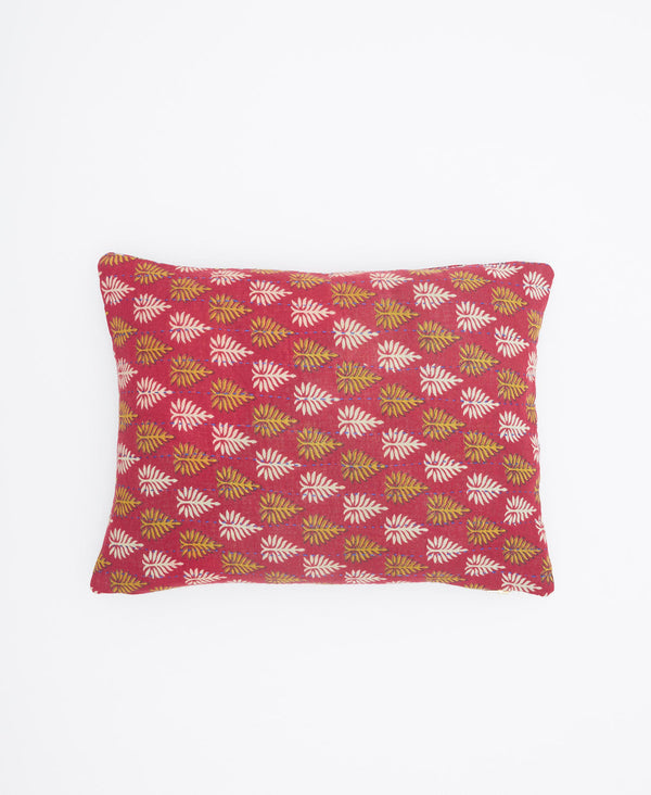 Red with a yellow and white leaf print, this small throw pillow is the perfect decor 