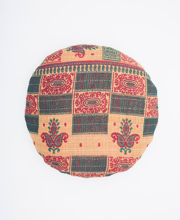 red, green, and tan round pillow created using upcycled vintage saris 