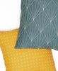 Forest green and yellow hand-embroidered throw pillows with modern geometric and cross-stitch pattern