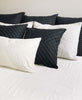 modern boho organic cotton pillow arrangement on contemporary bed