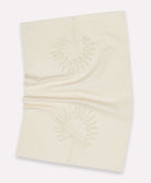 Wrinkled light ivory kitchen towel with a Chamaerops leaf in green stitching