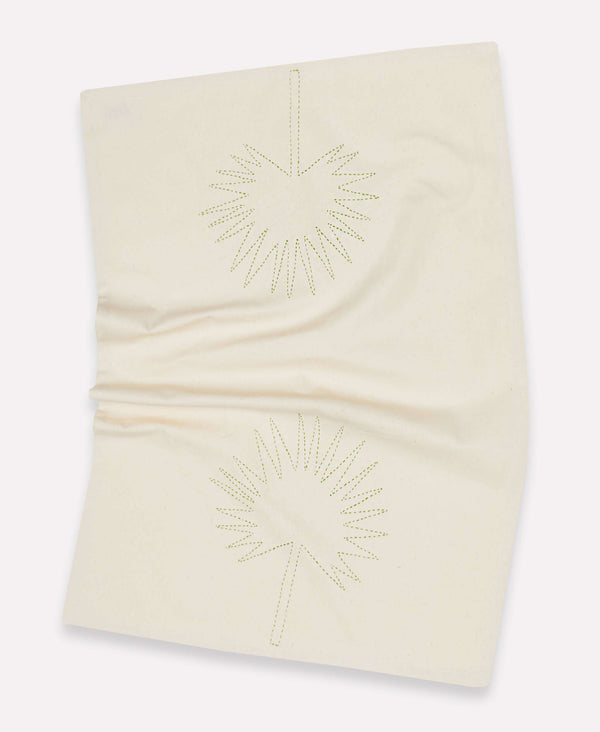 Wrinkled light ivory kitchen towel with a Chamaerops leaf in green stitching