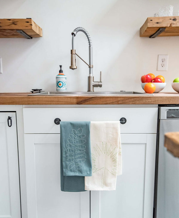 embroidered plant tea towels hanging in kitchen by Anchal Project
