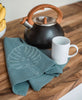 hand-embroidered organic cotton tea towel with plant design