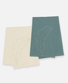 Bone white tea towel contrasting with bright blue/green tea towel both featuring hand stitched details on organic cotton