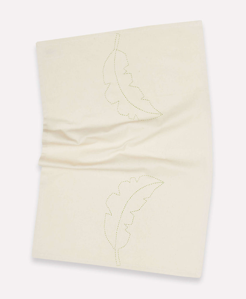 Off white kitchen towel that features green hand stitched palm print for a unique look