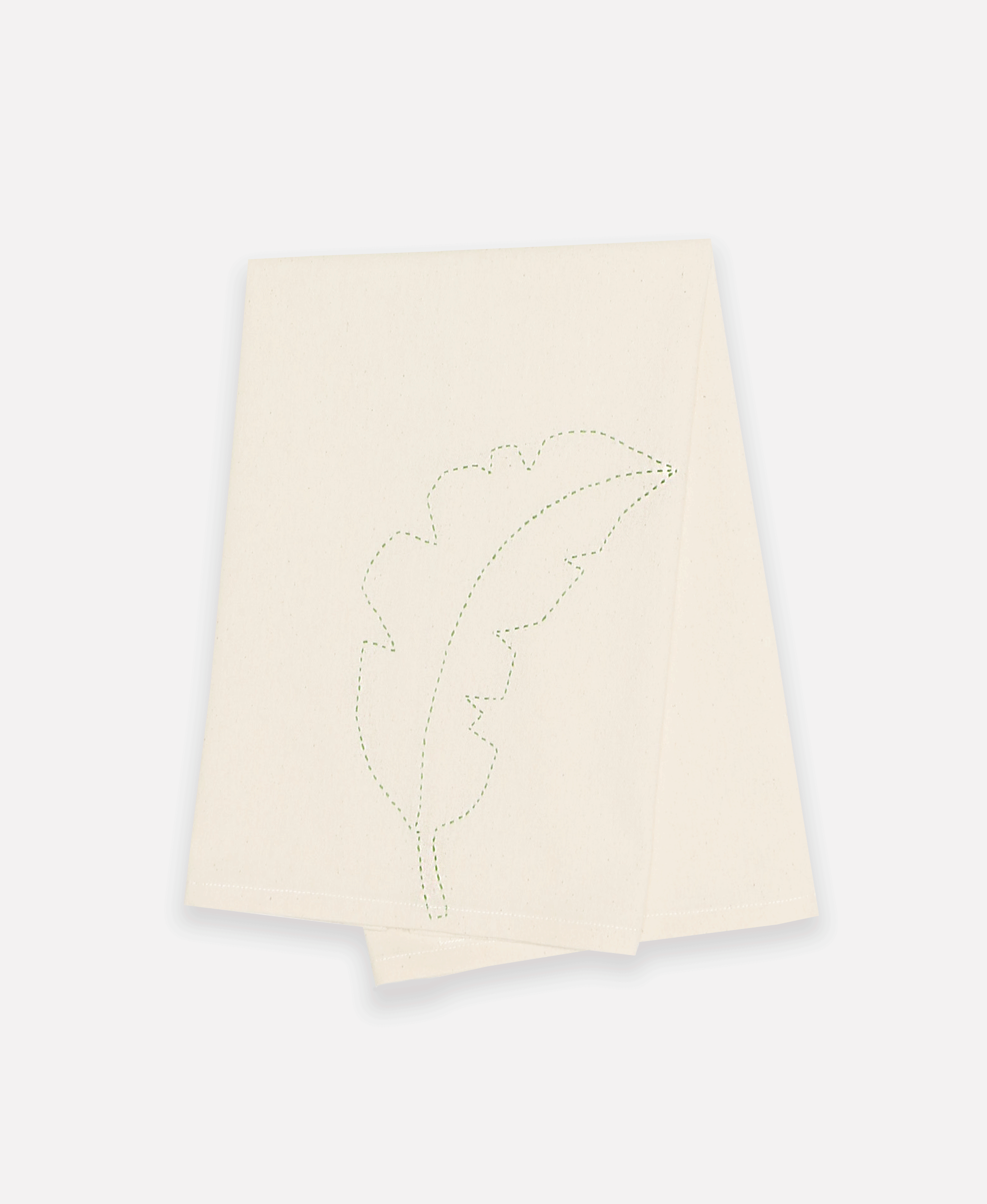 Folded kitchen hand towel that features green hand stitching of a unique palm leaf print