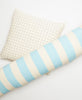 blue and white striped pillow and white cross-stitch throw pillow by Anchal Project
