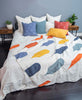 baby blue bedroom with bright, colorful quilt draped on bed