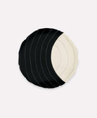 Round pillow in black and white with hand-stitched and colorblock design