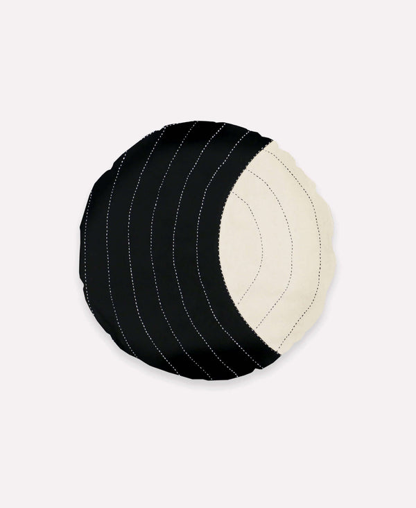 Round throw pillow with hand stitched and colorblock design