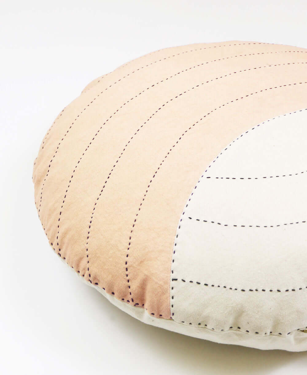 Two-tone crescent accent pillow with hand-stitched pattern and zipper closure