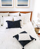 Sustainable home decor in a bedroom styled with matching bedding and pillows