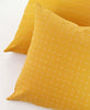 pair of hand-stitched modern throw pillows in mustard yellow