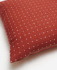 minimalist cross-stitch throw pillow by Anchal Project in rust red