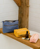 grouping of organic cotton toiletry bags with hand stitched details by Anchal