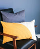 mustard curve pillow in modern leather chair by Anchal