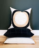 contemporary circle pillow stacked on top of hand embroidered pillows
