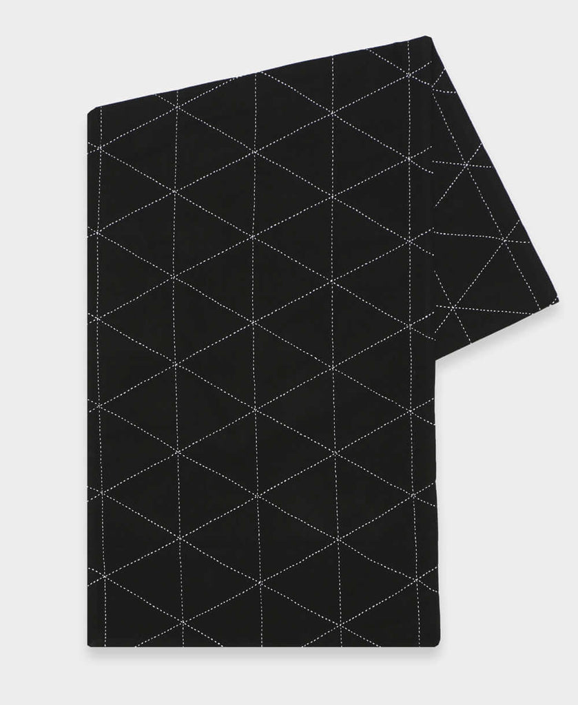 black grid pattern embroidered table runner made from organic cotton in India by women artisans