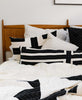 black and white geometric organic cotton bedding featuring interlock lumbar pillow in charcoal