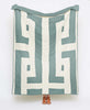 White organic cotton quilt featuring teal geometric design
