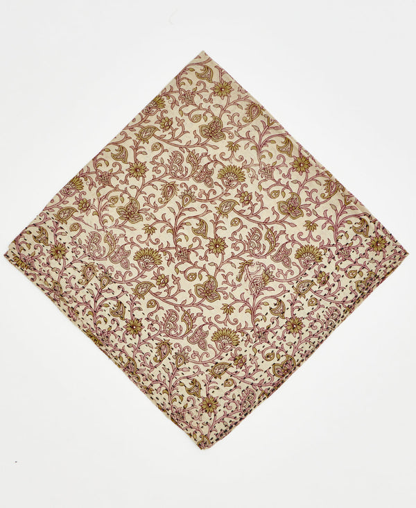 beige cotton bandana with pale pink and green swirling flowers and vines and black traditional kantha stitching
