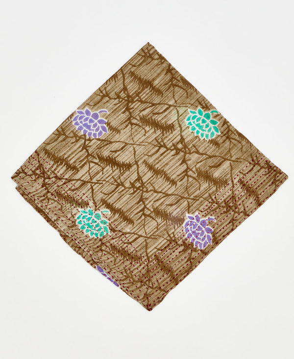 brown cotton bandana with large teal and purple flowers and a dark brown diamond pattern