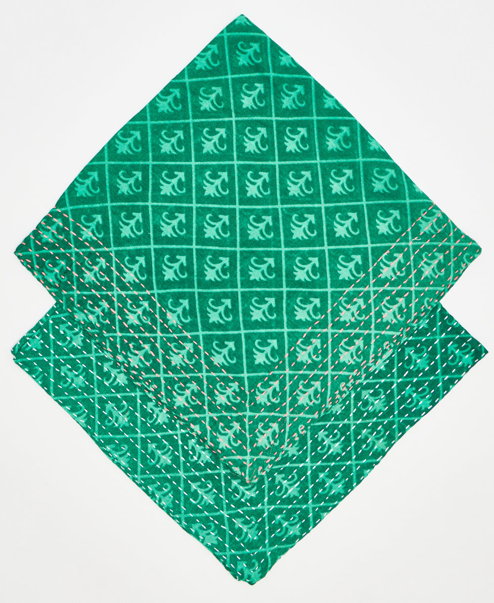 two green and teal cotton bandanas stacked on each other to show the different thread colors. one has pale pink kantha stitching along its edges while the other has white kantha stitching