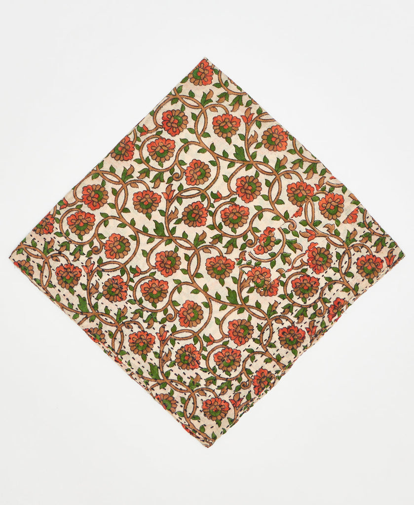 white cotton bandana with orange, brown, and red siwrlng flowers and vines and black traditional kantha stitching along its edges