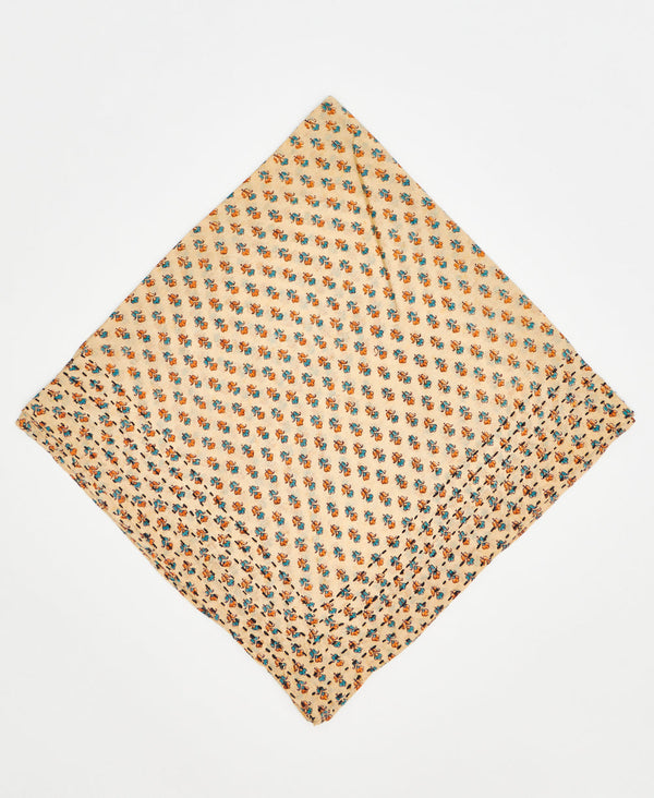 pale yellow cotton bandana with small and dainty blue and orange flowers and black kantha stitching along its edges