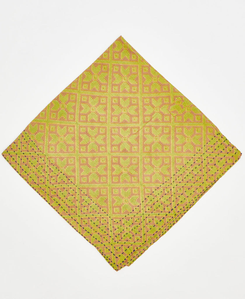 beige cotton bandana with a neon green repeating floral geometric pattern and black traditional kantha stitching along its edges