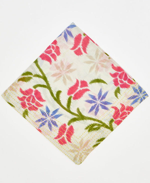 white cotton bandana with large green vines, red flowers, and purple flowers and traditional yellow kantha stitching along its edges