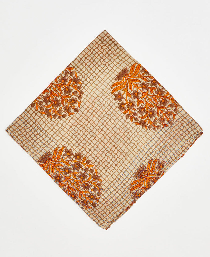 beige cotton bandana with a brown grid and orange trees 