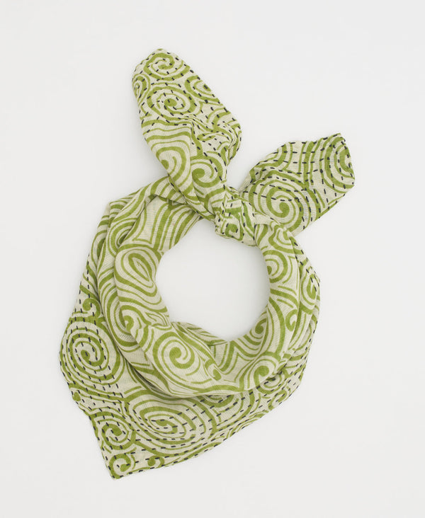 white cotton bandana featuring a green swirl print and navy kantha stitching 