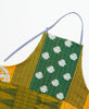 Green and yellow printed apron featuring tie details, three pockets, and kantha stitching 