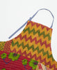 Yellow, red, and green chevron printed tie detail apron featuring three large pockets 