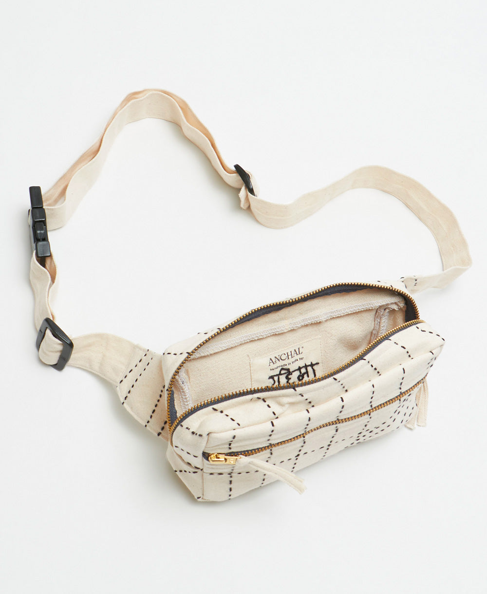 small modern fanny pack with hand-embroidered grid pattern and adjustable strap