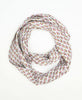 Bright white traditional cotton infinity scarf that has small detailed pink and yellow flowers