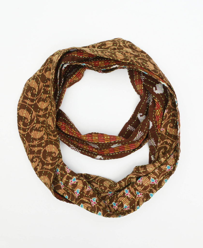 Deep brown traditional cotton infinity scarf that features a hand stitched tag of the artisan that created the piece 