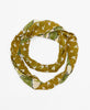 hand-made green infinity scarf that features the signature of the woman artisan on the tag