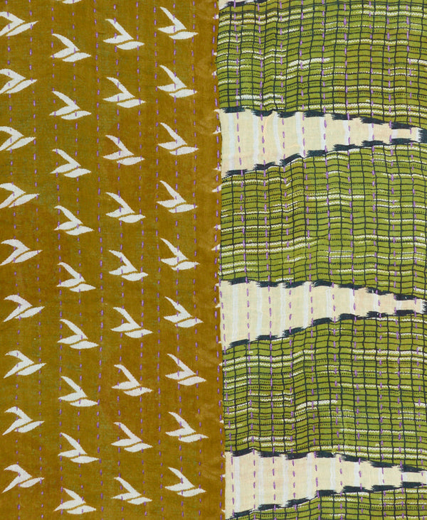army green background with white birds contrasts the hunter green side of the scarf with small black grid patterns, and white triangles on this eco-friendly scarf made of vintage saris 