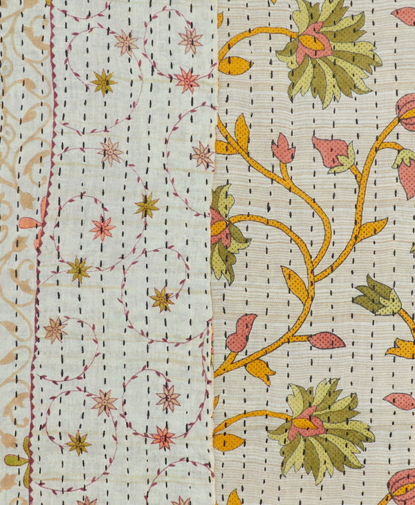 scarf with pale beige background featuring dainty floral swirls and pink, green, and orange flowers hand-stitched with black thread