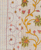delicate red swirling vines and large pink and green flowers with orange stems sit atop a pale beige background with blue traditional kantha stitching 