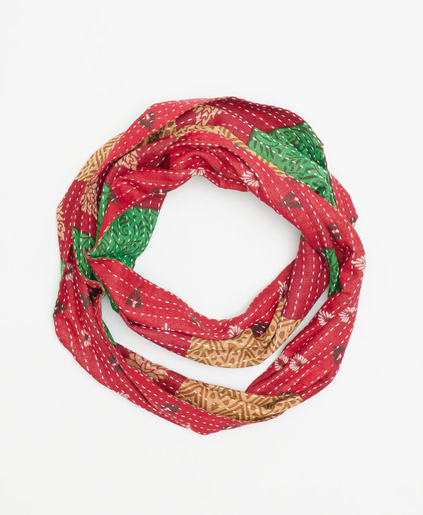 red infinity scarf with green and tan details hand-made by a woman artisan in Ajmer, India using upcycled vintage saris