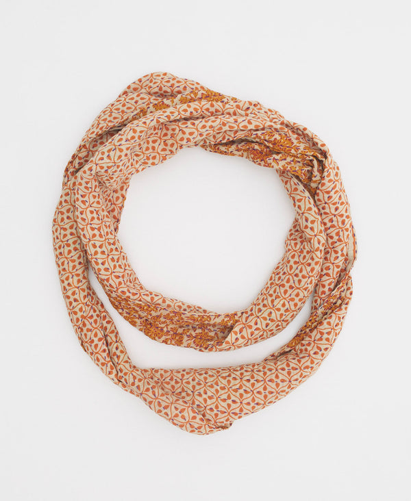 beige cotton infinity scarf with delicate orange floral details 